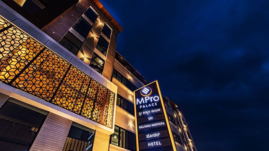 The facade of M Pro Palace featuring a signboard.