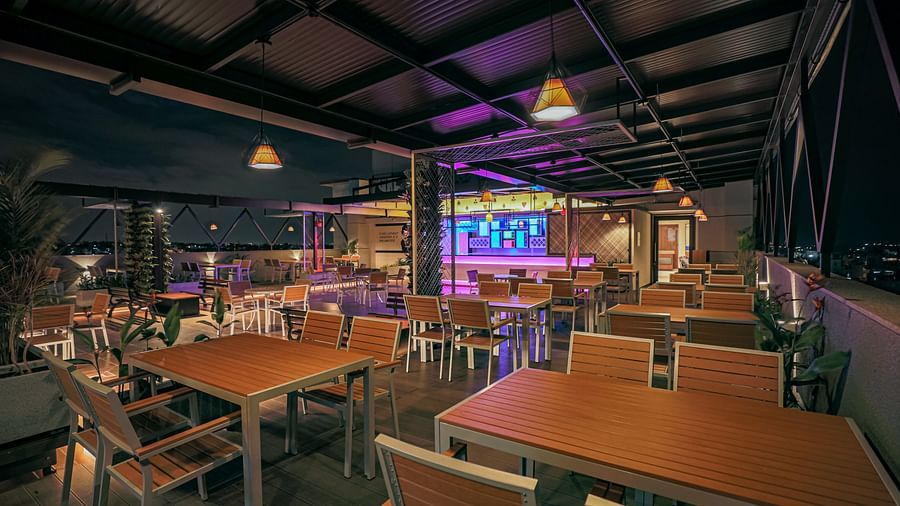 Image of a dining area with wooden tables and chairs at M Pro Palace.