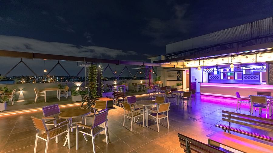 An image of a dining space with tables and chairs, complemented by an open roof at M Pro Palace.