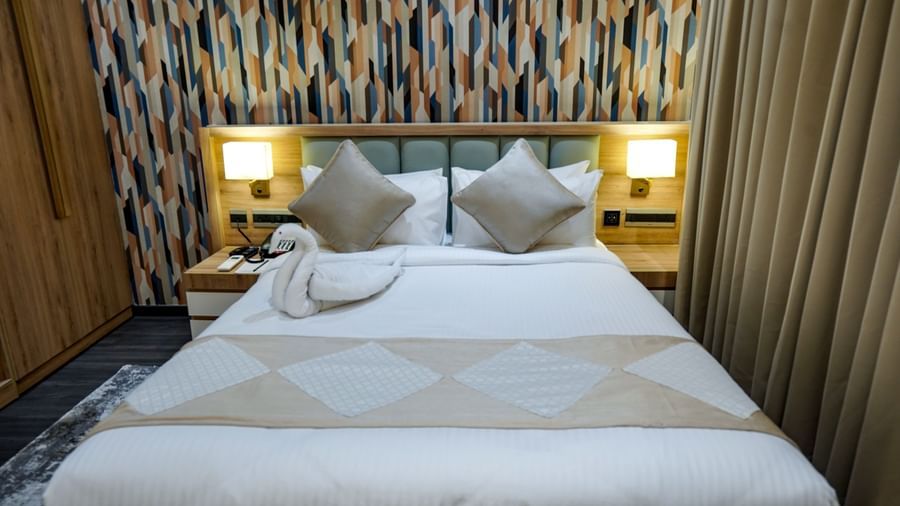 A close-up shot of the double bed at Deluxe Room at M2 Square by Monday Premium with swan made of towel kept on the bed.