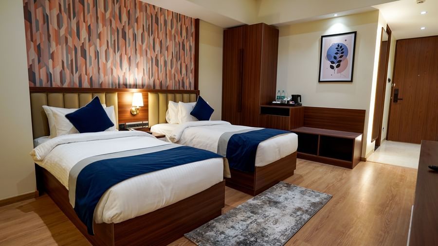 Corner view of the Superior Twin Bed Room with 2 single beds along with a rug in front of it at M2 Square by Monday Premium.