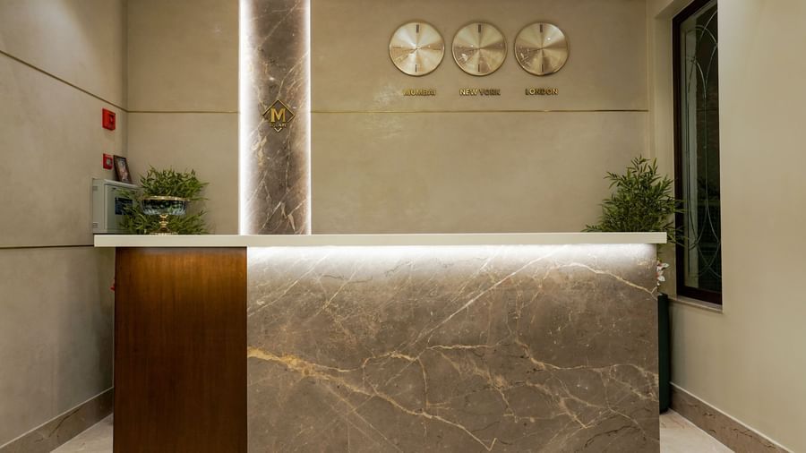Close-up shot of the reception desk and 3 wall-mounted clocks at M2 Square by Monday Premium.
