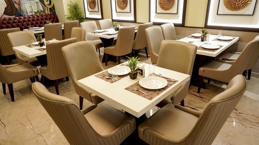 A close-up shot of a 4-seater dining table at the Mosaic restaurant featuring 2 plates on the table.