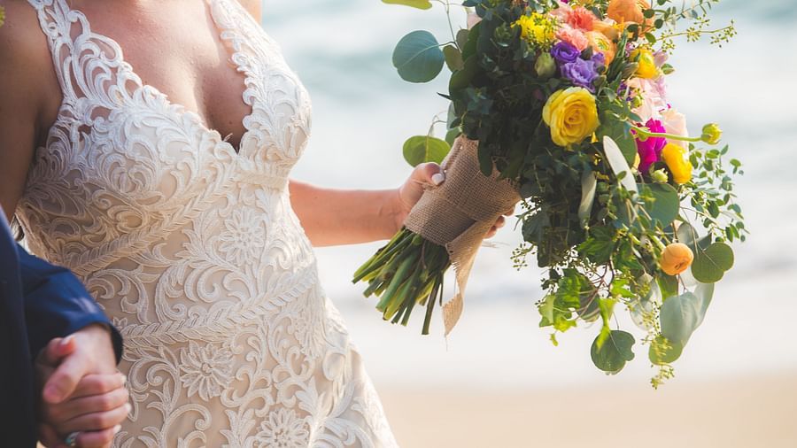 The bride and the flower bouquet in her hand - Maikhao Dream Villa Resort & Spa, Phuket