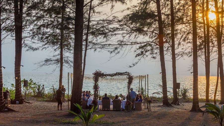 The wedding dinner from a far away perspective with a beautiful sunset in the background - Maikhao Dream Villa Resort & Spa, Phuket