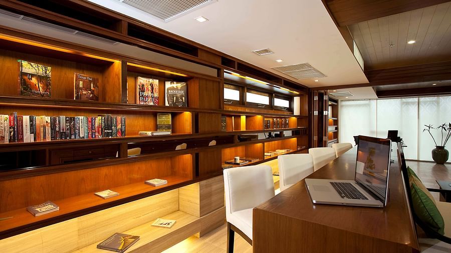 The business centre and library from a corner view with a table in front of the book shelf - Maikhso Dream Villa Resort & Spa, Phuket