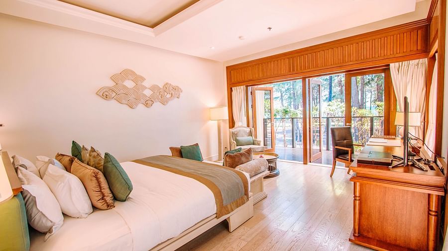 A bedroom featuring a king size bed with a lot of cushions on it - two bedroom private pool beachfront villa
