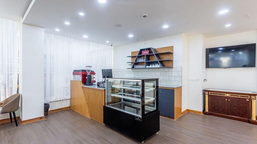 Billing Desk and Display Cabinet of the in-house cafe at Mandala Norling Lords Prime in Kathmandu and cutlery placed on designed shelves. 