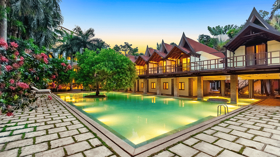Mango Hill Auroville resort with swimming pool in Pondicherry at twilight