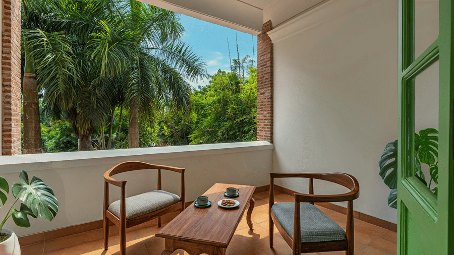 Private balcony room overlooking greenery at Mango Hill Auroville