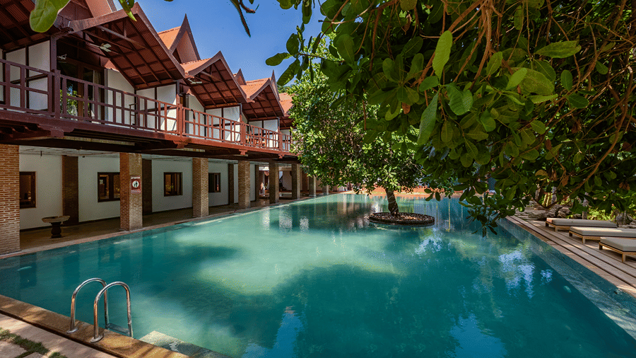 Swimming pool surrounded by villas at Mango Hill Auroville, Pondicherry