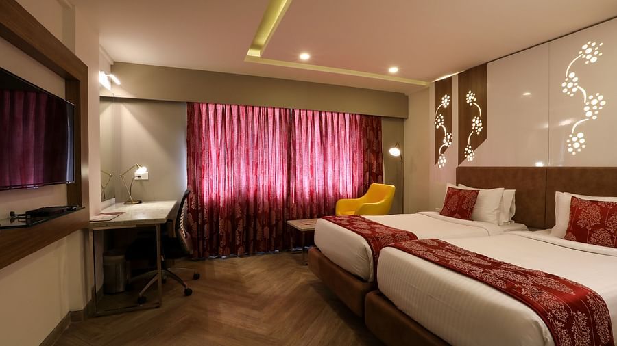 A bedroom with two single beds and a workdesk and chair - Mango Hill Central, Chennai