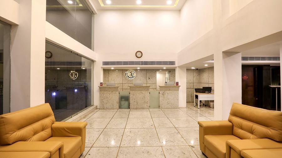 Reception of the property with chairs placed in front of the reception desktables and chairs in clusters in a restaurant - Mango Hill Central, Chennai