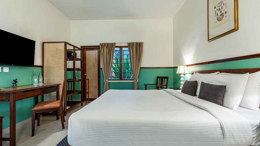 Well-appointed stay in Pondicherry with a king bed, a wooden desk and chair, a flat-screen TV, and storage | Mango Hill Shallow Beach Resort ECR