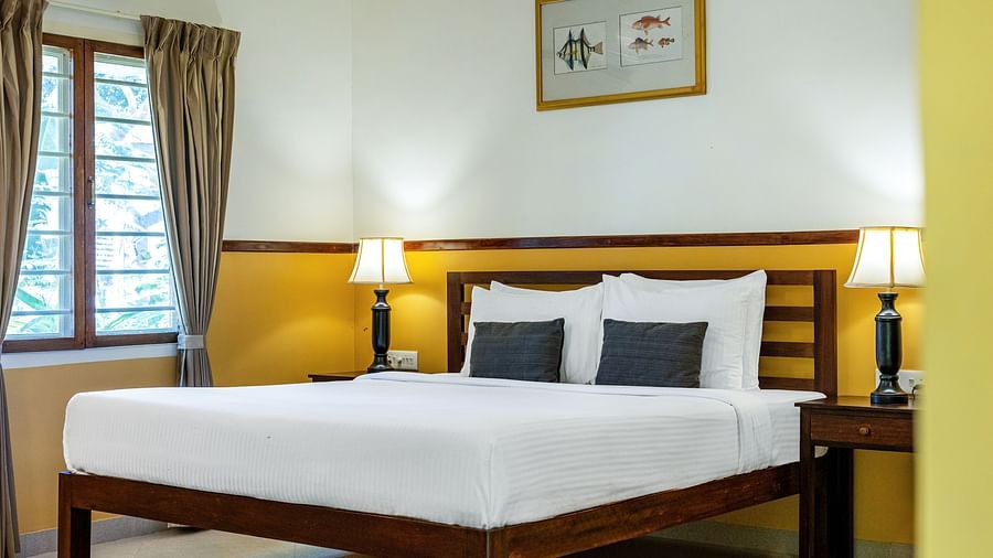  Double bed with nightstands and lamps in a plainly decorated room | Mango Hill Shallow Beach Resort ECR