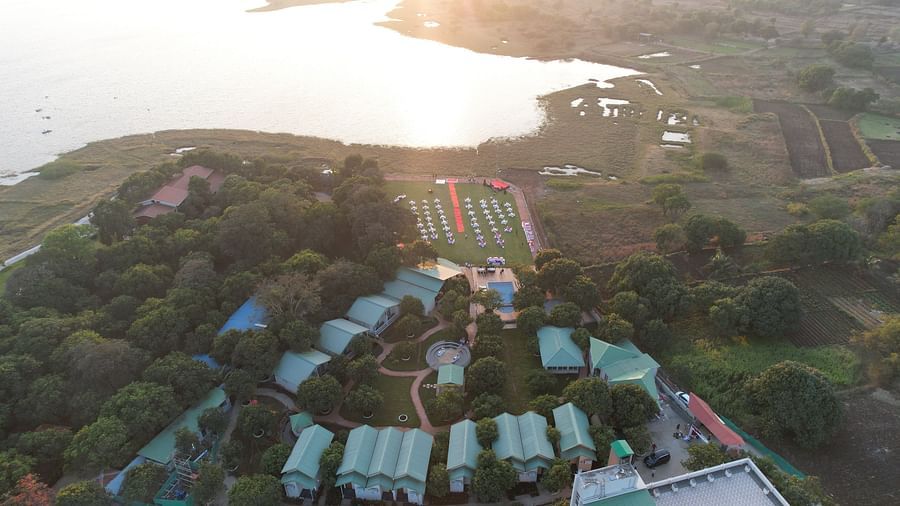 Panaromic view of the facade of Mango Leaf Lake Resort, Pune along with the lake in the backdrop