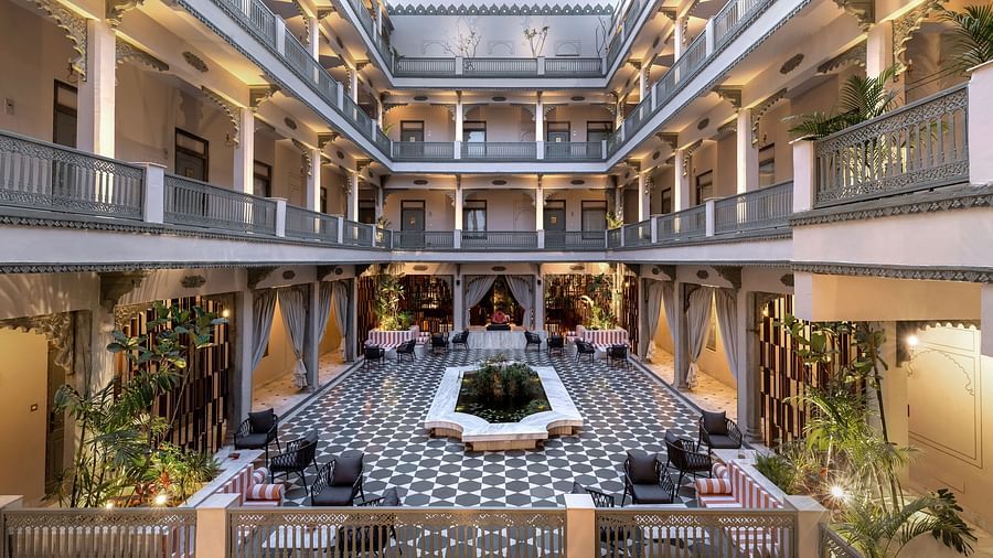 An overview of a courtyard with the inside of the building in view - Manuscript - Jhilwara Haveli, Udiapur