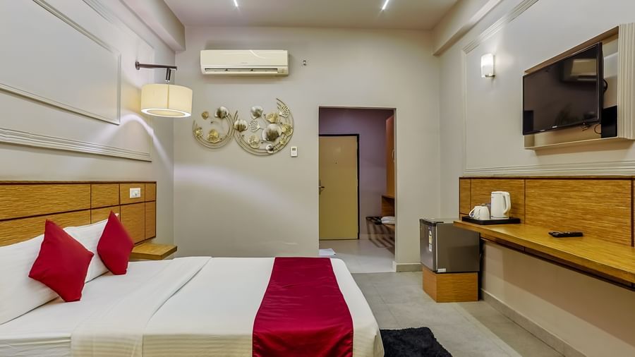Tidy room with side table and modern amenities at Max Hotel Prayagraj.
