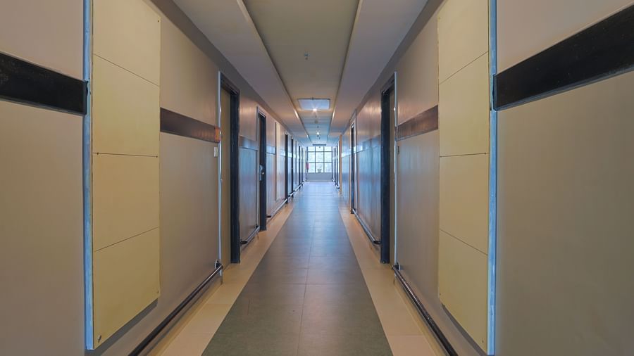 Corridor with sleek wall panels and bright lighting at Max Hotel Prayagraj.