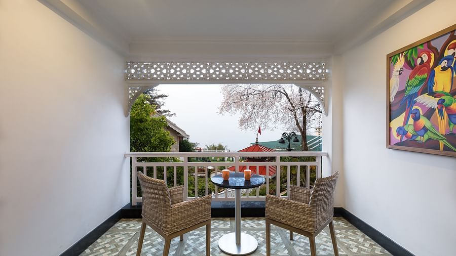 2 chairs at the attached balcony of a room - Mayfair Himalayan Spa Resort Kalimpong