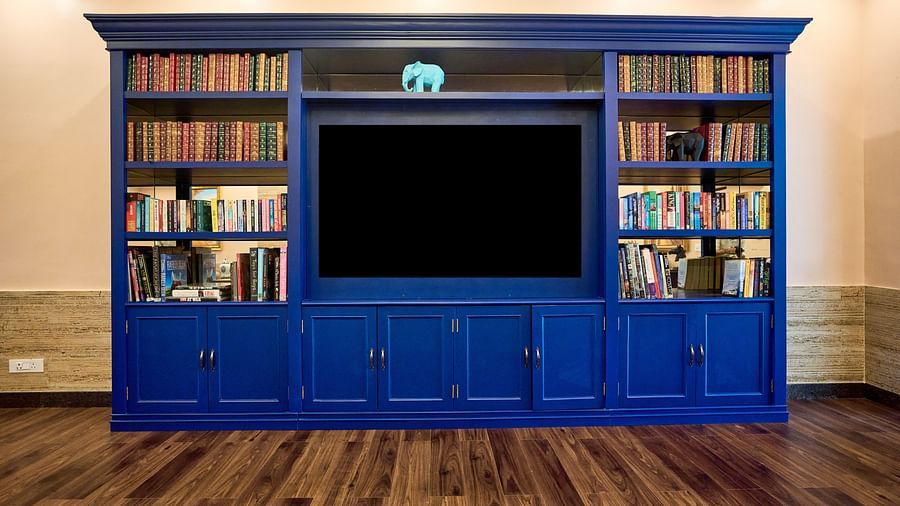 A large cupboard with books neatly arranged for display at Mayfair Manor, Alibag