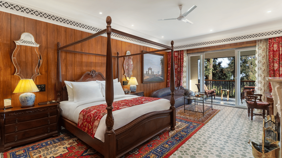 Spacious suite featuring a four-poster bed and terrace access at Mayfair Manor, Jungpana.