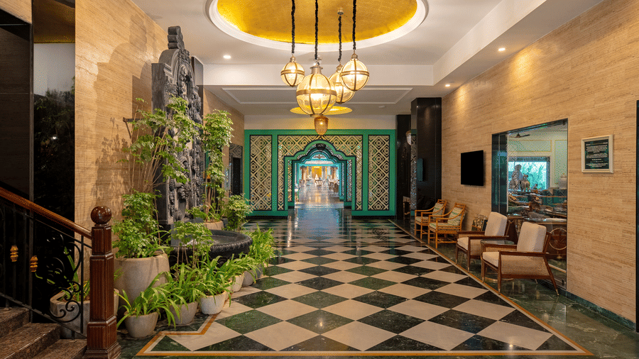 Hotel lobby with checkered flooring and chandelier at Mayfair Oasis Resort, Jharsuguda