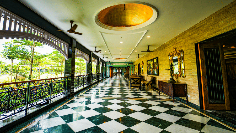 Elegant corridor with black and white checkered flooring at MAYFAIR Oasis Resort and Convention Jharsuguda