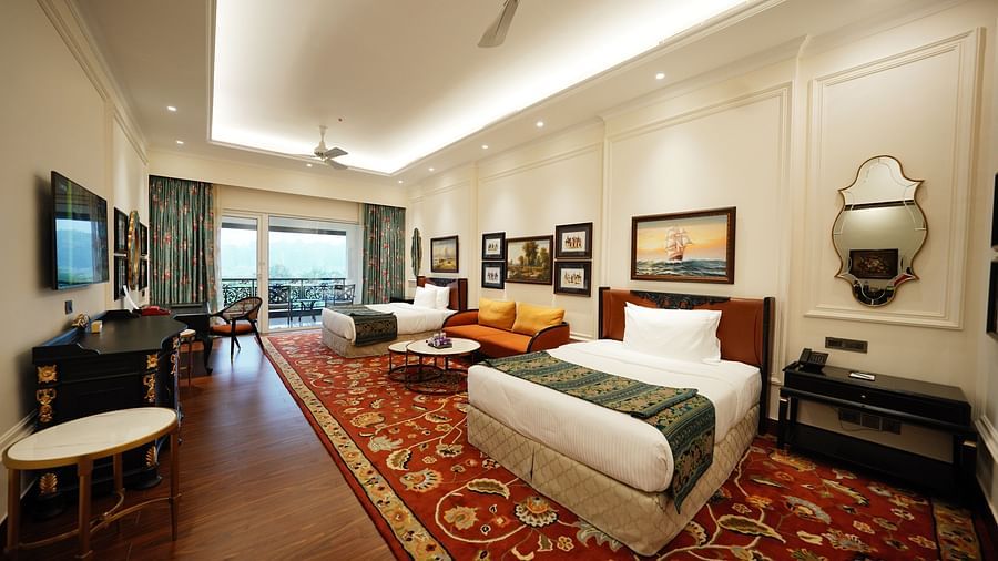 twin beds and walls are decorated with paintings - Mayfair Tea Resort, Siliguri 4