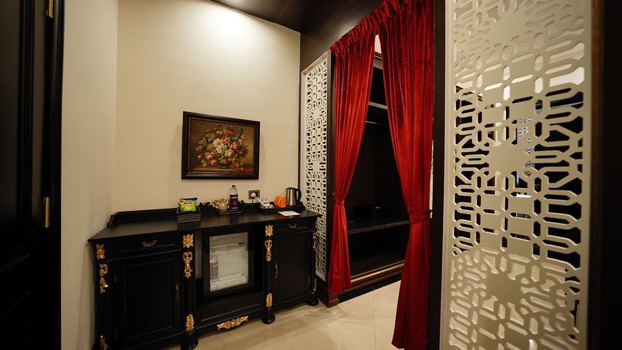 a room being bifurcated by red curtains - Mayfair Tea Resort, Siliguri
