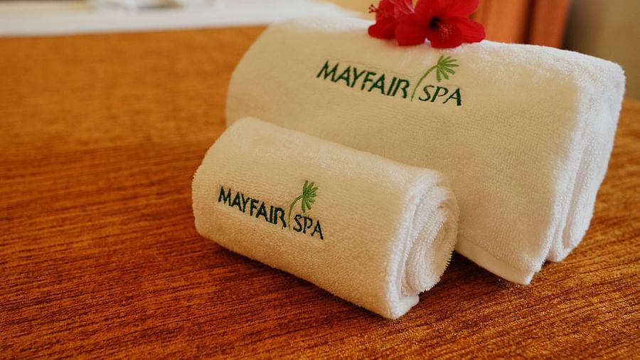 two folded towels with the name mayfair spa printed on them - Mayfair Tea Resort, Siliguri 