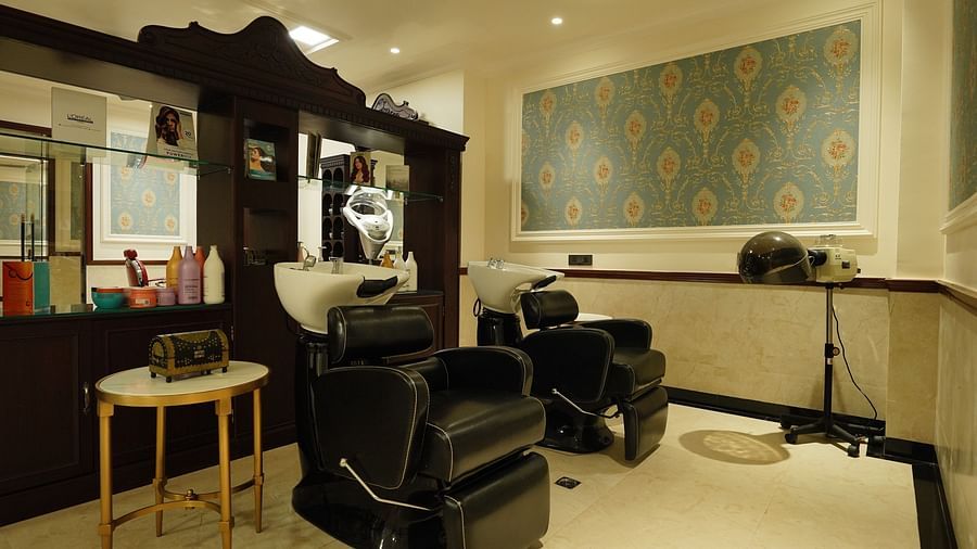 a salon with a rolling chair facing a mirror - Mayfair Tea Resort, Siliguri 00