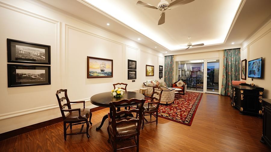 chairs and a sofa set facing a TV in the living room - Mayfair Tea Resort, Siliguri 