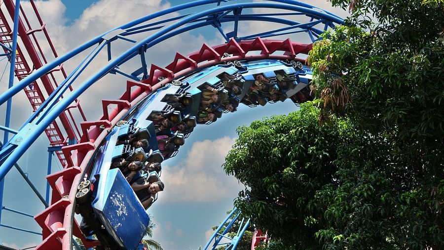 People on a roller coaster amusement park ride