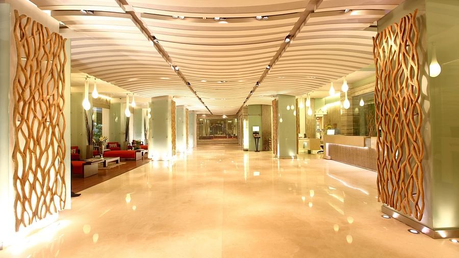 Image of the lobby at our hotel that is well-lit and has sofas on the left side. | Mirage Hotel