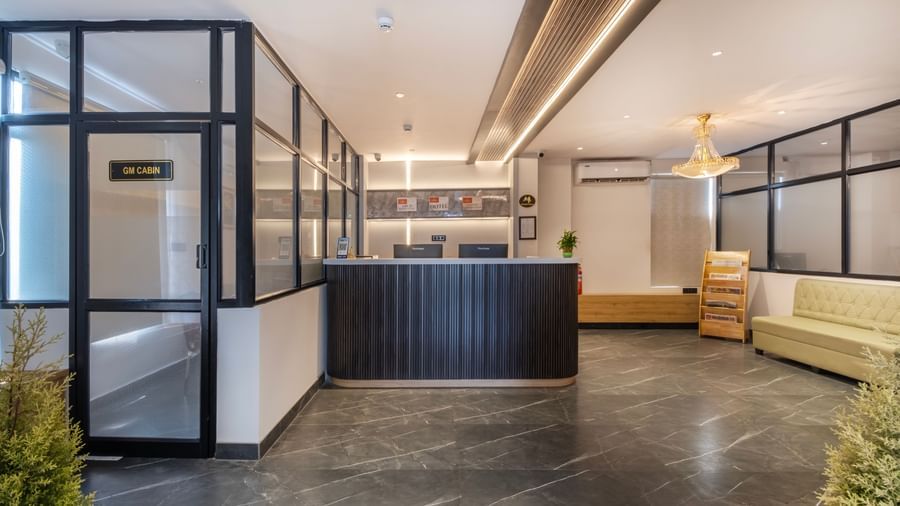 Contemporary lobby with seating and reception desk at Monday Hotels Amalapuram Heights.