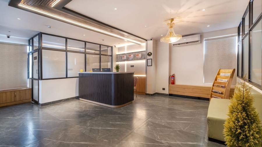 Spacious reception area with modern interiors and seating area at Monday Hotels Amalapuram Heights.