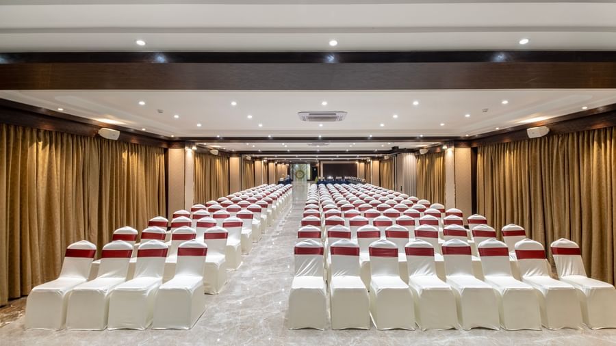Theatre seating arrangement with ambient lighting at Monday Hotels Amalapuram Heights banquet hall.