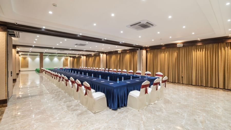 Banquet setup at Monday Hotels Amalapuram Heights with boardroom seating arrangement.