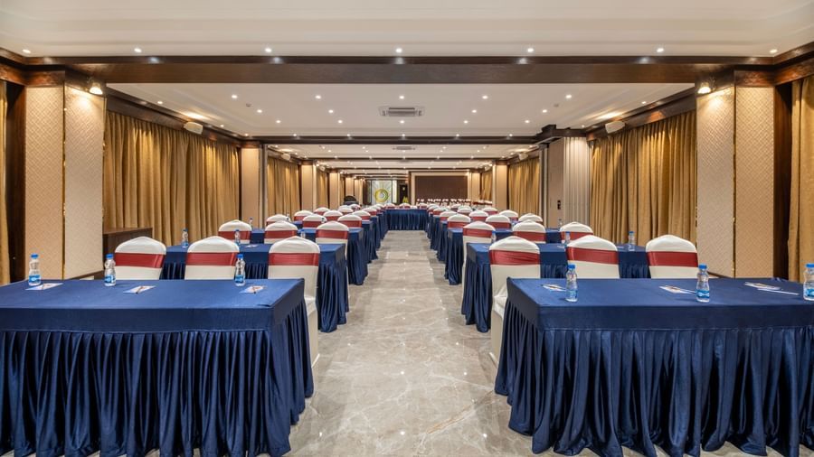 Spacious hall at Monday Hotels Amalapuram Heights with classroom seating arrangement.