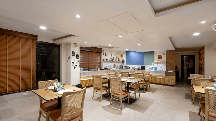 Contemporary dining area at Monday Hotels HITEC City Hyderabad with modern seating elegant lighting and spacious restaurant interiors