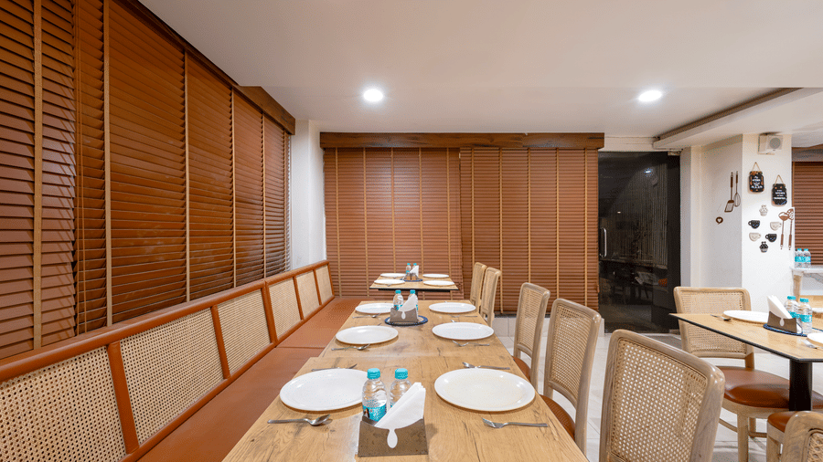 Elegant dining table setup at Monday Hotels HITEC City Hyderabad with neatly arranged seating ambient lighting and refined interiors