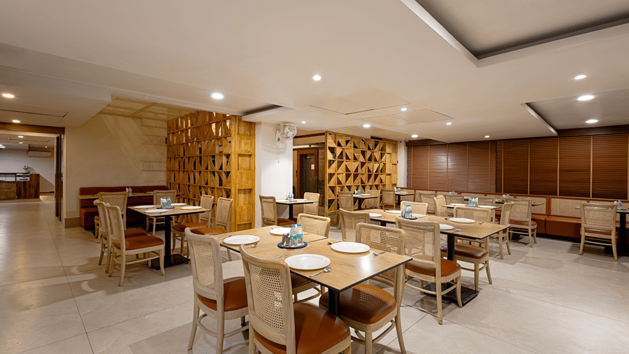 Dining area inside the Superior King Room at Monday Hotels HITEC City Hyderabad with a four-seater dining table, elegant lighting and modern decor.