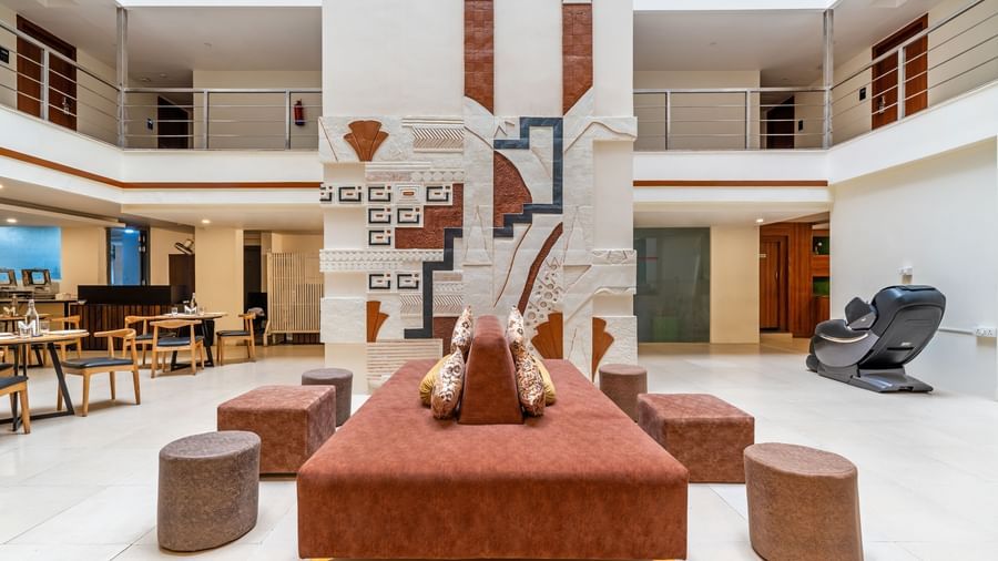 A spacious hotel lobby with seating arrangements and decorative elements - Monday Hotels HITEC City, Hyderabad