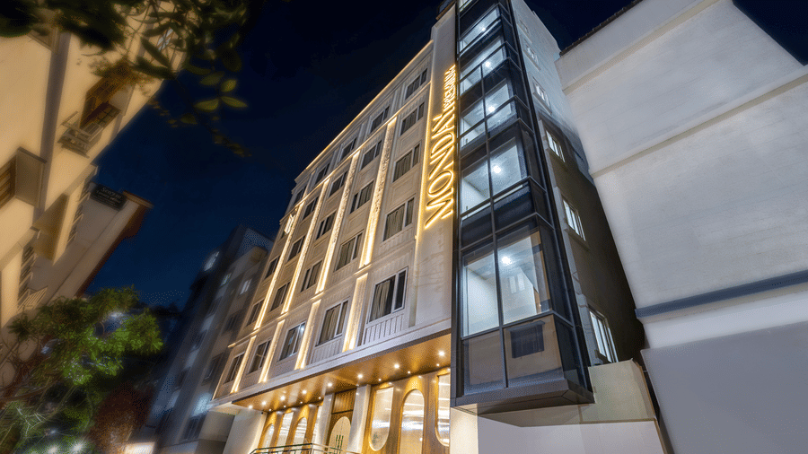 The facade of Monday Premium, Madhapur, featuring buildings surrounding it.