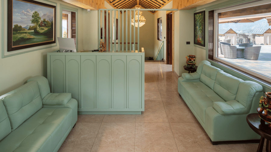 The Reception area at Leisure Hotels with 2 sofas facing each other at Mountoria Retreat, Naukuchiatal