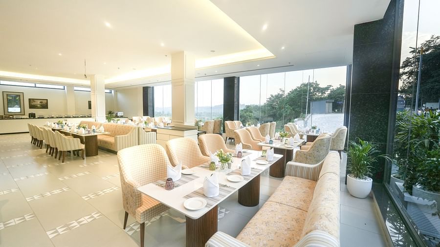 An image of a restaurant with tiled flooring, cosy furniture, and dining tables near a floor-to-ceiling window - NAMAMI BY ZENQ BANKHANDI