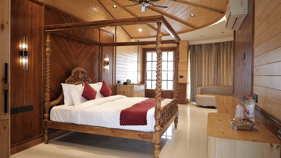 Bliss Bloom Suite featuring a king bed, stylish décor, and modern wooden furnishings.