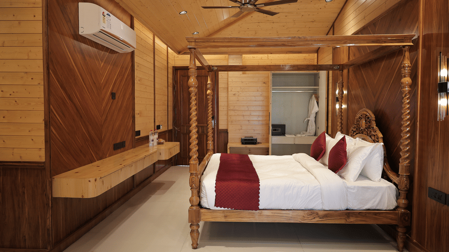 Comfortable Bliss Bloom Suite interior with king bed, dressing area, and warm ambient lighting.