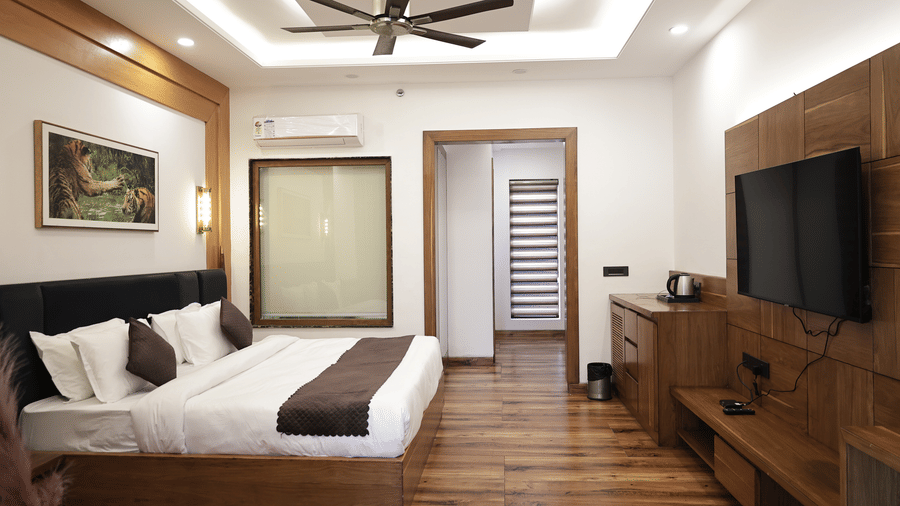 Elegant master bedroom of the Presidential Suite featuring a king bed and warm lighting.